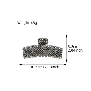 Large vintage alloy hair claw clip with rhinestones and measurement details on white background
