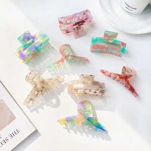 Elegant acetate hair claws with marble and floral patterns in various stylish shapes