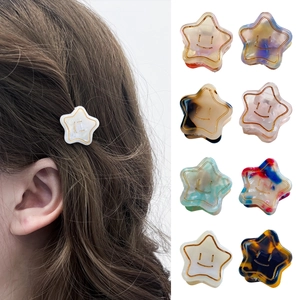 Star-shaped acetate hair claws with smiley face patterns and gold accents in 8 colors
