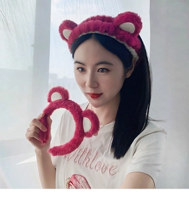 Détail d'un bandeau en peluche rose avec oreilles d'ours pour le maquillage