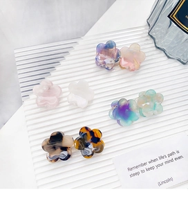 Set of eight mini floral acetate hair claws in pastel and tortoise shell patterns