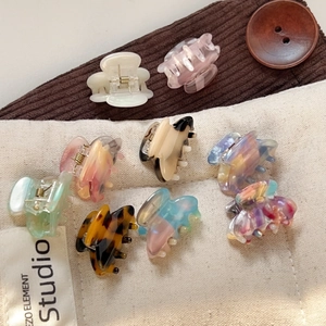Set of 8 minimalist acetate hair claws with diverse marble and tortoiseshell patterns