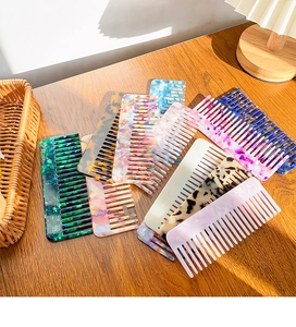 Detail of colorful acetate hair combs with marble patterns and tortoiseshell finish