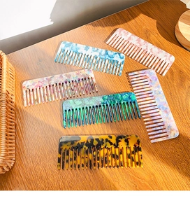 Detailed view of acetate hair combs in various colorful marble and tortoise patterns