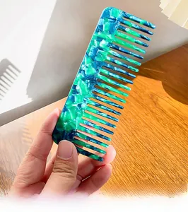 Detail showing smooth wide teeth and blue green marble texture of the acetate hair comb