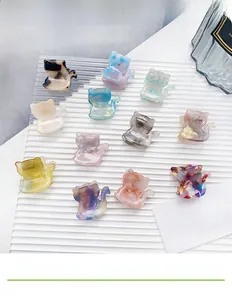 Close-up of cute cat-shaped acetate hair claws in various marble colors and patterns
