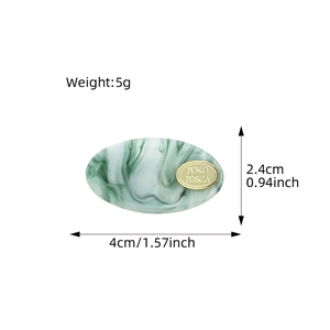 Green marble acetate hair clip with gold metal plate shown in overhead view with dimensions