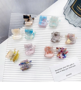 Set of eleven colorful acetate cat-shaped hair claws with elegant marble patterns