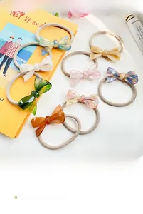 Flat lay of seven colorful acetate bow hair ties with elegant marble patterns
