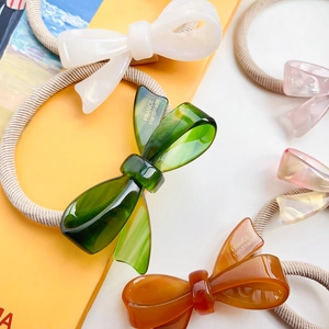 Chic acetate bow hair ties in dark green, cream and amber colors for high ponytails