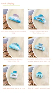 Detail view of sky blue geometric hair claws showing sizes and marble textures