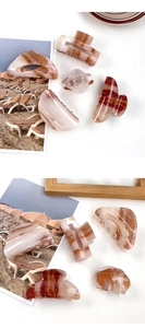 Close-up of marble amber pattern on high-quality acrylic hair claws and clips