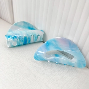 Sky blue marble acetic acid hair claws with geometric cutout and minimalist Korean style