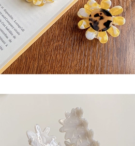 Macro detail of tortoiseshell floral hair claw clips with elegant marble textures