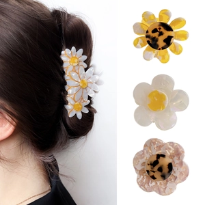 Floral claw clips with Daisy and marble acetate designs for elegant French hair styles