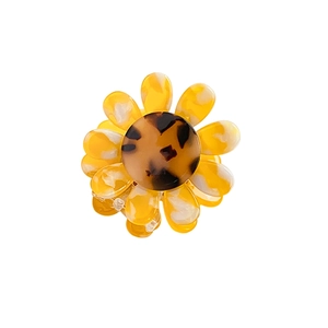 Floral hair claw clip with yellow marble pattern and tortoise shell center on white background