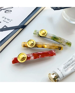 Close-up of premium acetate hair clips set with gold buttons in vintage leopard texture