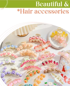Detailed view of colorful fruit and floral hair claws in pastel acrylic finishes