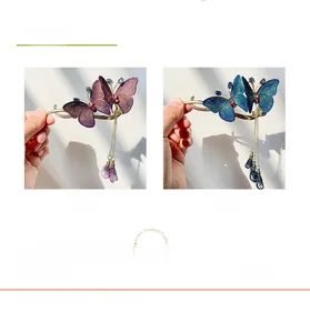 Detail of Chinese style embroidered butterfly hair clips with tassels in purple and blue
