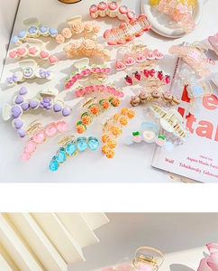 Detailed macro view of assorted macaron fruit and flower shark hair claws in bright colors