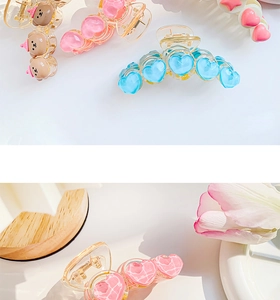 Detail of colorful resin fruit hair claws with heart and bear shapes for girls