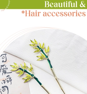 Detailed view of bamboo leaf hair pin with green enamel and golden metal finish