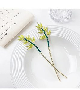 Detail of two Chinese bamboo leaf hairpins with green enamel and gold finish