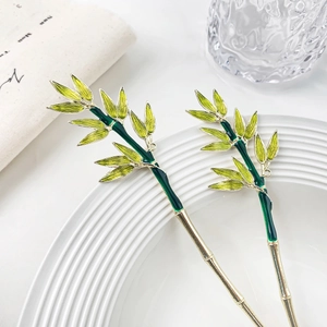 Bamboo leaf hair pin set with emerald green enamel finish in polished gold metal