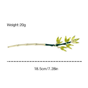 Bamboo style hair pin with green enamel leaves in gold metal finish 18.5cm long