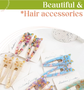 Detailed view of colorful cat-shaped acetate hair clips with vibrant marble patterns
