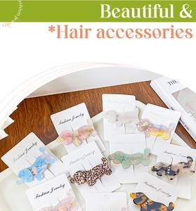 Macro shot of dachshund acetate hair clips with sparkling crystals and marble patterns