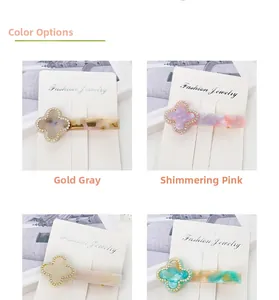 Macro detail of clover hair clips with resin finish and rhinestones in four colors