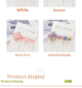 Detail of four-leaf clover hair clips with small rhinestones in multiple colors
