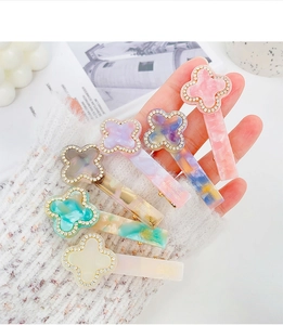 Detailed view of handmade acetate clover hair clips with sparkling rhinestones set of six