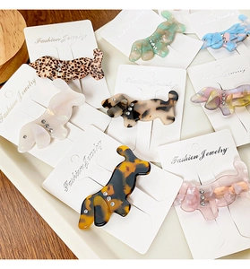 Detailed macro view of acetate dachshund dog hair clips with stylish marble patterns