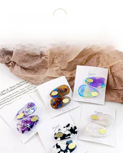Macro detail of acetate hair clips in various patterns on branded display cards