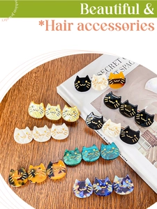 Detail of three-cat hair clips in acetate finish on minimalist lifestyle background