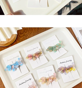Macro shot of colorful dachshund puppy acetate hair clips with crystal rhinestone accents