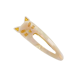 Cute cream-white cat hair clip with gold details and a glossy acetate finish