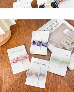 Detailed view of colorful acetate cat hair clips set on a stylish fashion display card