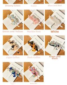 Detailed grid showing eleven colorful acetate cat hair clips on branded cards