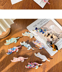 Detailed close-up of acetate cat hair clips in various marble and tortoiseshell patterns