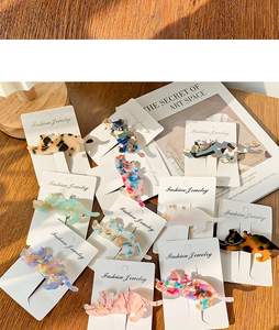 Detail of assorted cat-shaped acetate hair clips with vibrant marble and tortoiseshell patterns