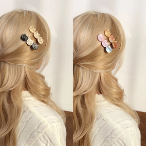 French vintage style cat hair clip set in assorted acetate colors on a blonde model