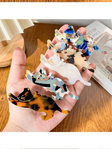 Detail showing high-quality acetate cat hair clips with marble and tortoiseshell patterns