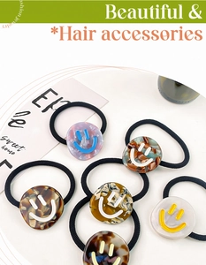 Macro shot of acetate hair ties featuring colorful tortoiseshell marble patterns and smiley faces