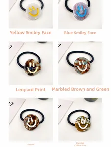 Detail view of high-elasticity hair ties in six colors with acetate smiley faces