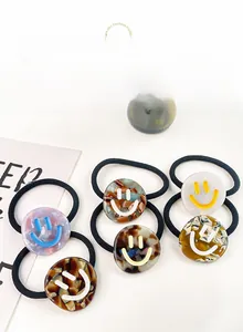 Detail of high-elasticity hair ties with colorful acetate charms featuring smiley face patterns