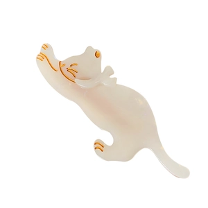 Pearlescent white cat-shaped acetate hair clip with gold detailing on a white background