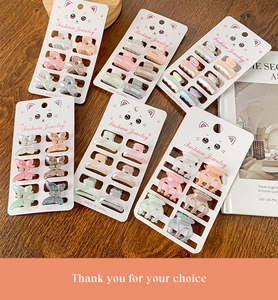 Détail de 6 mini pinces à cheveux colorées sur une carte de présentation de chat